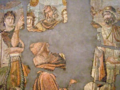 Fragments of a mosaic showing men's faces and arms, one wearing a helmet