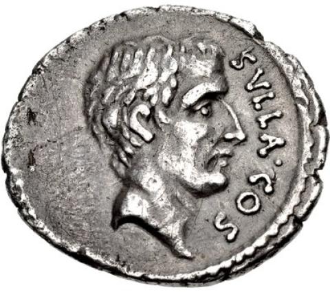 A silver coin with a short-haired man's head facing right. Around the right edge of the coin is written "SVLLA COS"