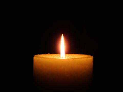 Lighted candle with black background
