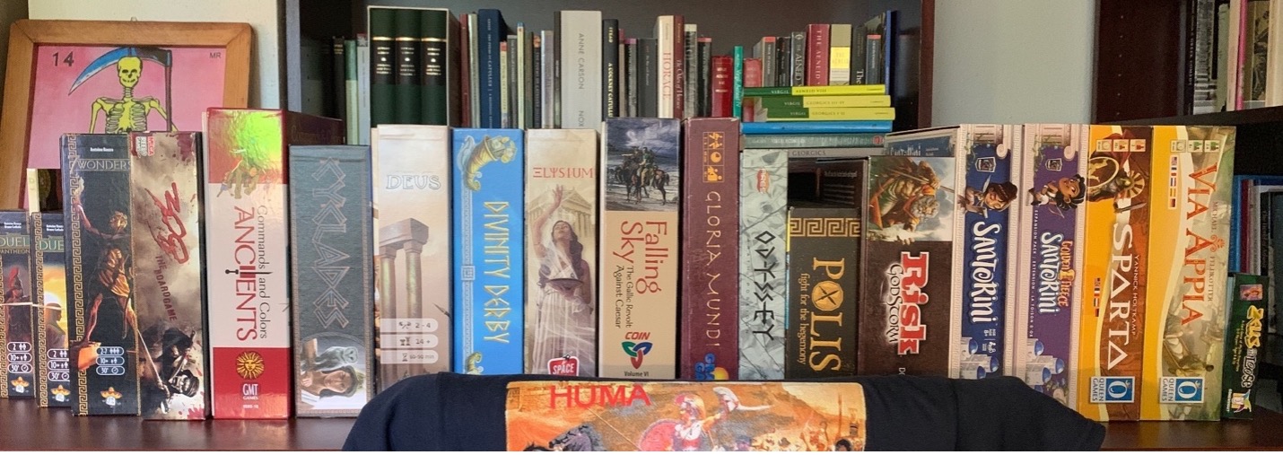 A row of board game boxes on a table.