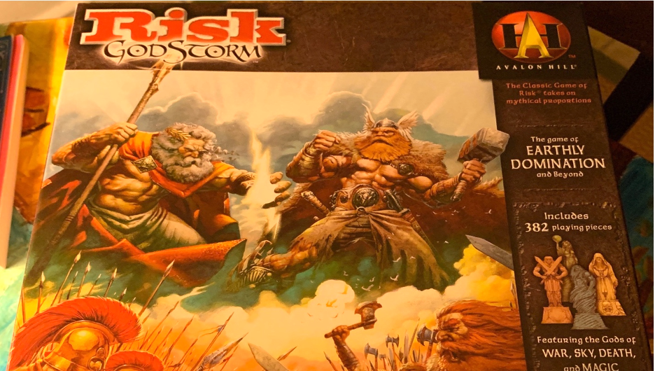 The box of a board game featuring two cartoon men, shirtless and very muscular, carrying a staff and a hammer and wearing cloaks.