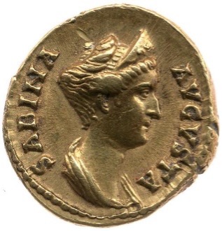 A dull gold coin featuring an image of Sabina looking to the right. Her hair is loosely secure into an updo.